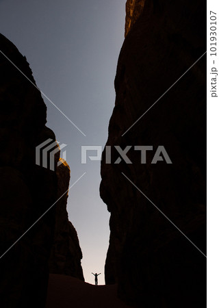 Amazing scale, silhouette of woman in a canyon 101930107