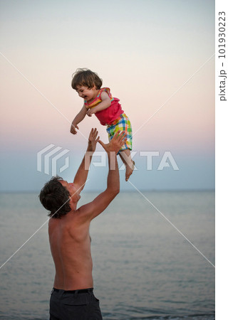 Father having fun with her daughter at sea Father having fun with her daughter at sea 101930223