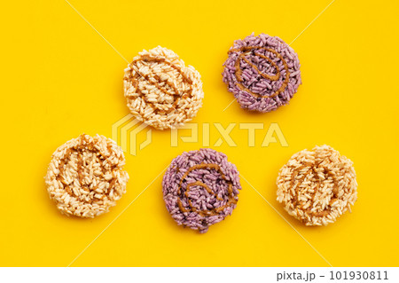 Rice cracker with coconut palm sugar on yellow background. Rice cracker with coconut palm sugar on yellow background. 101930811