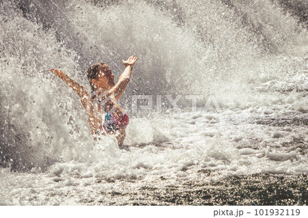 Beautiful lady staying by the waterfall 101932119