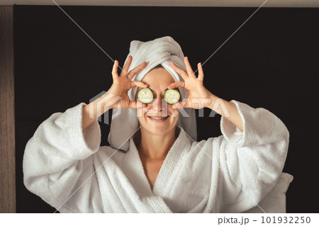 young woman getting eye nature treatment by cucumber at luxury spa resort. Wellness and healing concept. 101932250