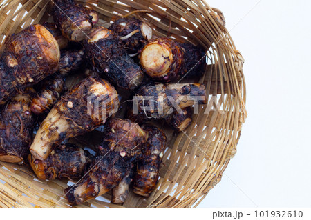 Organic taro fruit in bamboo basket on white background. Organic taro fruit in bamboo basket on white background. 101932610