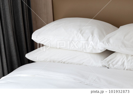 Bed with white pillows in bedroom Bed with white pillows in bedroom 101932873