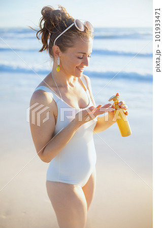 happy elegant woman in white swimsuit at beach 101933471