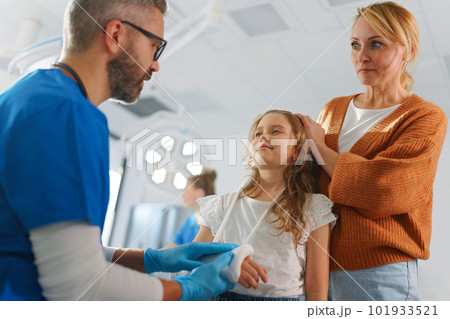 Mature doctor giving gypsum to little girl. 101933521