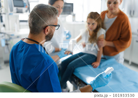Little girl with her mother in surgery examination. 101933530