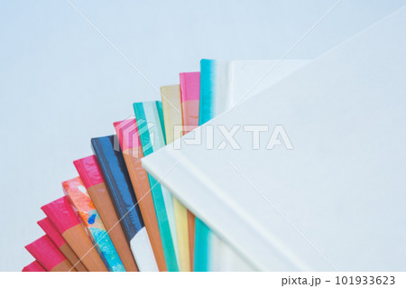 multi-colored spines of photo books close-up, partial blur 101933623