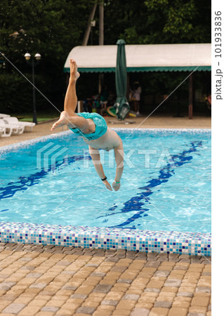 Portrait of handsome man jumping and diving into the swimming pool. Portrait of handsome man jumping and diving into the swimming pool. 101933836
