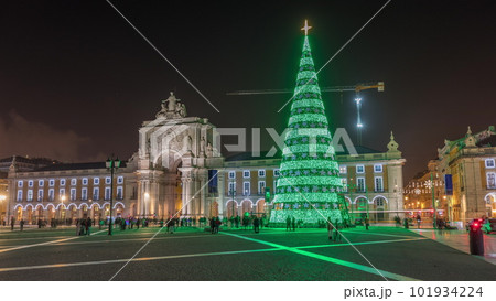 Commerce square illuminated and decorated at Christmas time in Lisbon night timelapse hyperlapse 101934224