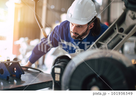 Engineer technician team service checking heavy industry machine robot welding arm head maintenance Engineer technician team service checking heavy industry machine robot welding arm head maintenance 101936349