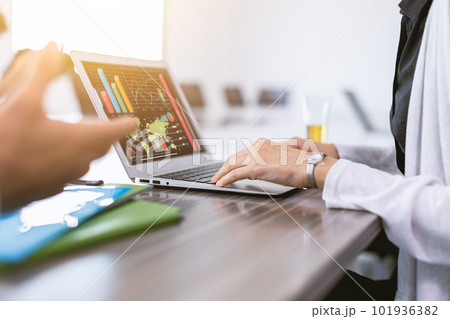 closeup businesswoman hand typing in laptop computer with business chart company information in screen closeup businesswoman hand typing in laptop computer with business chart company information in screen 101936382