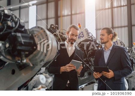 Businessman working in machinery factory robot assembly plant team working together Businessman working in machinery factory robot assembly plant team working together 101936390