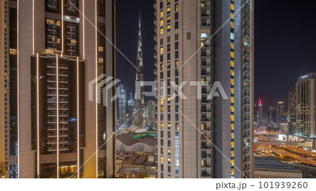 Tallest skyscrapers in downtown dubai located on bouleward street near shopping mall aerial night timelapse. Tallest skyscrapers in downtown dubai located on bouleward street near shopping mall aerial night timelapse. 101939260