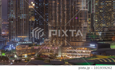 Shopping mall exterior with reastaurants day to night timelapse in Dubai, United Arab Emirates 101939262