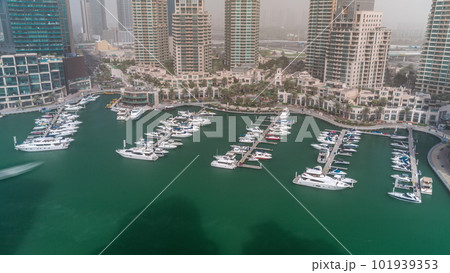 Luxury boats and yachts docked in Dubai Marina aerial all day timelapse. 101939353