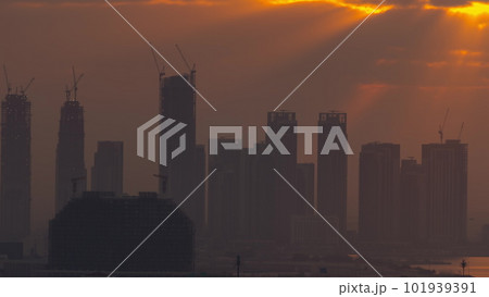 Sunrise over Dubai Creek Harbor with skyscrapers and towers under construction aerial timelapse Sunrise over Dubai Creek Harbor with skyscrapers and towers under construction aerial timelapse 101939391