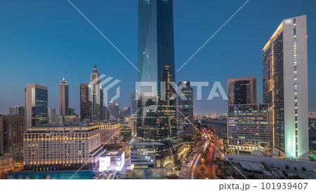 Dubai International Financial district aerial day to night timelapse. Panoramic view of business and financial office towers. 101939407