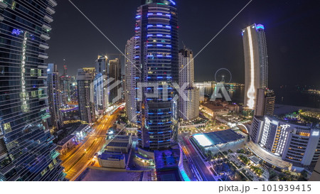 Panoramic view of the Dubai Marina and JBR area and the famous Ferris Wheel aerial night timelapse 101939415