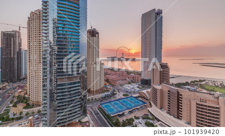 Panoramic sunset view of the Dubai Marina and JBR area and the famous Ferris Wheel aerial timelapse 101939420