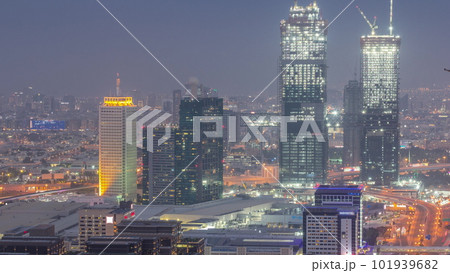 Aerial view of skyscrapers with World Trade center in Dubai day to night timelapse. 101939682