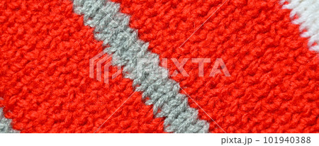 Handmade knitted fabric red and grey wool background texture Handmade knitted fabric red and grey wool background texture 101940388