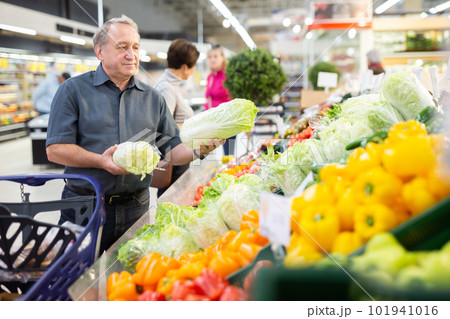 elderly man chooses china cabbage in vegetable and fruit department 101941016