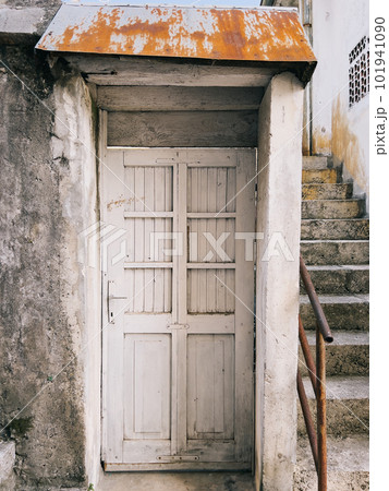 White wooden door in an old stone wall White wooden door in an old stone wall 101941090
