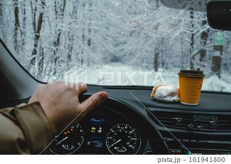 On a winter forest background, fast food on a dashboard On a winter forest background, fast food on a dashboard 101941800