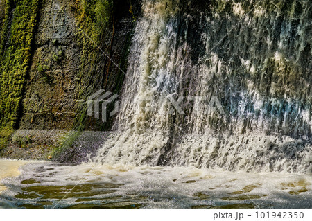 Pleasant freshness.River dam with clear flowing water on a warm sunny day Pleasant freshness.River dam with clear flowing water on a warm sunny day 101942350