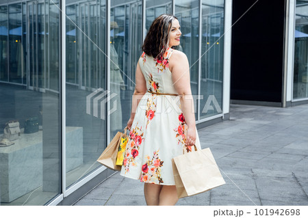 How to Shop for Summer Fashion on a Budget. Choosing the Right Fabrics for Hot and Humid Summer Weather. Outdoor portrait of stylish curvy woman with shopping bags How to Shop for Summer Fashion on a Budget. Choosing the Right Fabrics for Hot and Humid Summer Weather. Outdoor portrait of stylish curvy woman with shopping bags 101942698