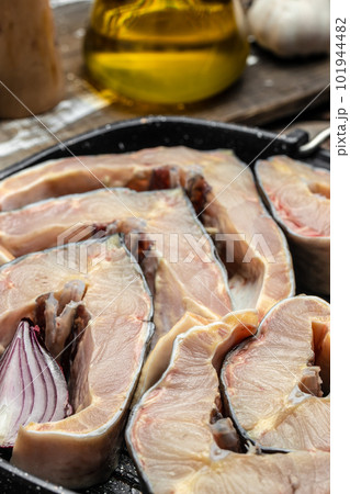the chef holds steaks of large raw sturgeon fish. Culinary, cooking, bakery concept the chef holds steaks of large raw sturgeon fish. Culinary, cooking, bakery concept 101944482