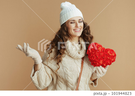 happy stylish woman against beige background with red heart 101944823