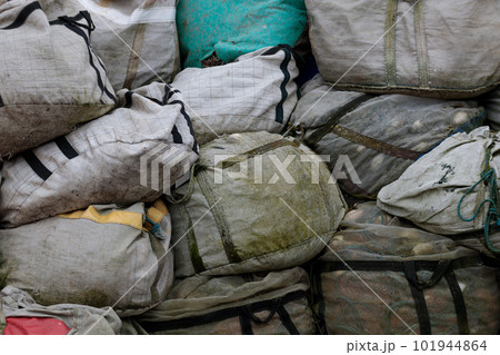 Old fishing nets in bags, close-up. A pile of old fishing net Old fishing nets in bags, close-up. A pile of old fishing net 101944864