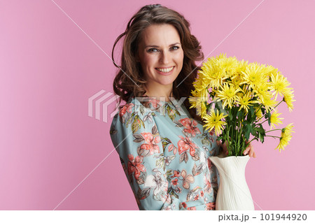 Portrait of happy modern woman in floral dress on pink 101944920