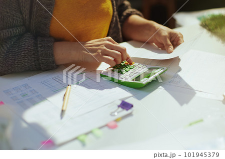 accountant woman with calculator and documents working 101945379