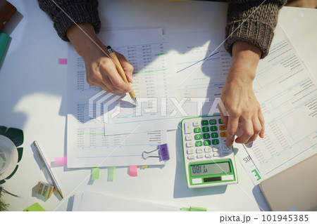 accountant woman with calculator and documents working 101945385