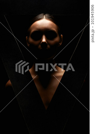 beautiful brunette woman in triangle. portrait of girl silhouette in the dark 101945906