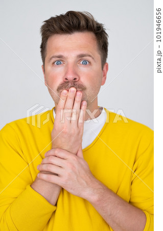 Surprised and Shocked caucasian man covering mouth with hands 101946656