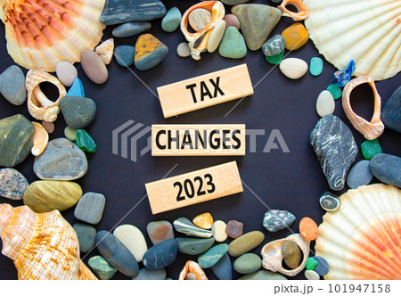 Tax changes 2023 symbol. Concept words Tax changes 2023 on wooden blocks on a beautiful black table black background. Sea stone, sea shell. Business Tax changes 2023 concept. Copy space. 101947158