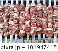 Appetizing shashlik skewers with raw lamb on grill, top view 101947415