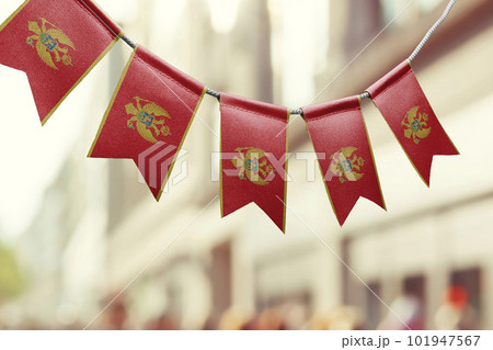 A garland of Montenegro national flags on an abstract blurred background 101947567