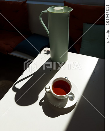 Tea set in the cafe hard light with harsh shadows 101947811