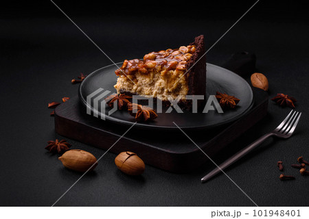 Delicious fresh cheesecake cake or snickers with cream and nuts Delicious fresh cheesecake cake or snickers with cream and nuts 101948401