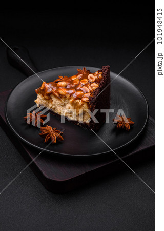 Delicious fresh cheesecake cake or snickers with cream and nuts 101948415