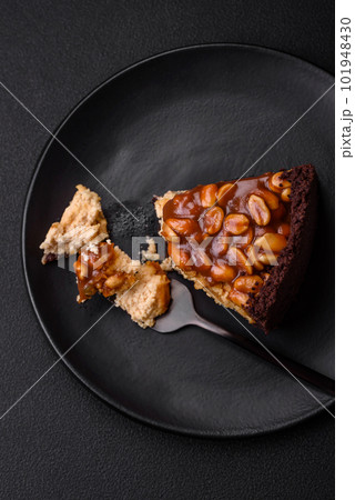 Delicious fresh cheesecake cake or snickers with cream and nuts 101948430