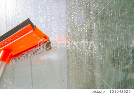 Window washing. Cleaning the window with a brush and foam. The concept of cleanliness and cleaning. 101948629