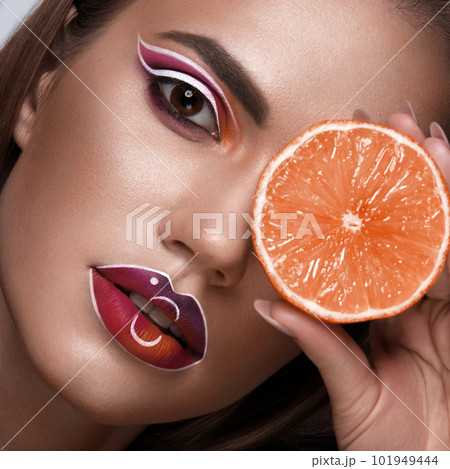 Beautiful caucasian woman with creative makeup and purple lips. Beauty face. Art makeup. Beautiful caucasian woman with creative makeup and purple lips. Beauty face. Art makeup. 101949444