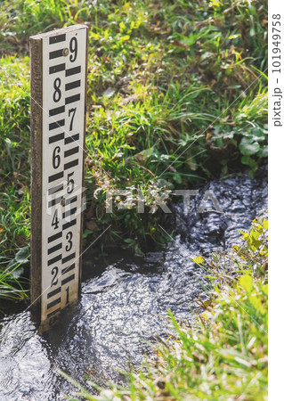 Wooden tide gauge in a stream in Slovenia 101949758