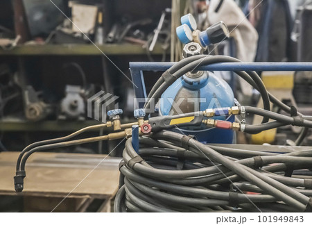 Gas cylinder, hose and blowtorch at the factory Gas cylinder, hose and blowtorch at the factory 101949843