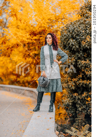 A woman walks outdoors in autumn, enjoys the autumn weather. 101950294